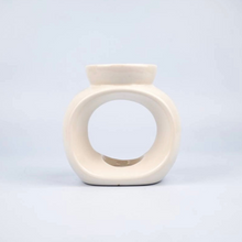 A small Solara ceramic burner in white with an oval shape and a deep dish designed to hold wax melts.