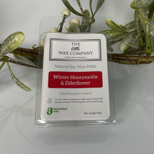 Pack of The Little Wax Company wax melts with decorative mistletoe in the background