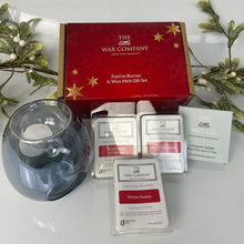 The Little Wax Company gift set with a wax melt burner and wax melts on a white surface with Christmas decorations.