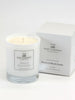 A white candle with a label that reads 'Peony & Blush Suede' alongside a white candle box, both with the brand 'THE LITTLE WAX COMPANY' visible.