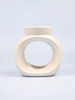 A small Solara ceramic burner in white with an oval shape and a deep dish designed to hold wax melts.