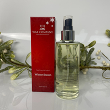 Bottle and box of The Wax Company Winter Season room spray on a white background with mistletoe.