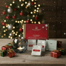 Wax melts and packaging with a Christmas tree in the background