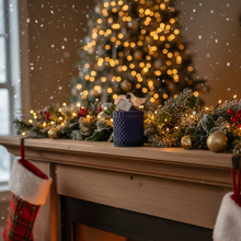 Decorated Christmas tree and mantel with lights and ornaments in a cozy room.