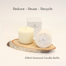 A 230ml Diamond candle refill placed on a wooden disc, with the brand's packaging box in the background, showcasing the product with the text 'Reduce - Reuse - Recycle' and the product name.