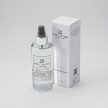 A 150ml clear room spray bottle with a white label and a black spray nozzle, next to its white box packaging with the brand name and product title.
