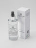 A 150ml clear room spray bottle with a white label and a black spray nozzle, next to its white box packaging with the brand name and product title.